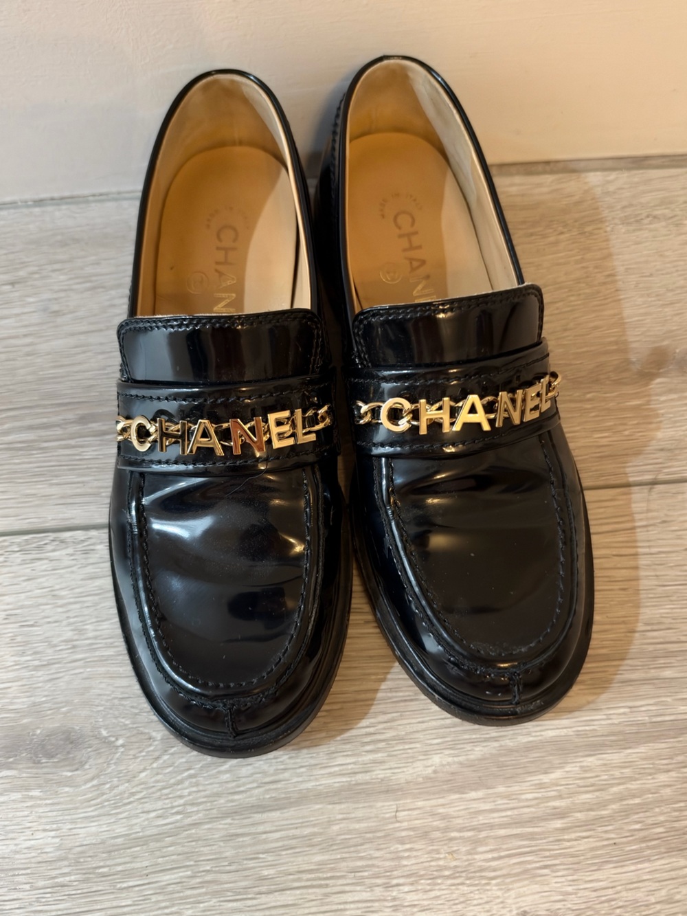 CHANEL Black Patent Leather Loafers with Gold Chain Logo